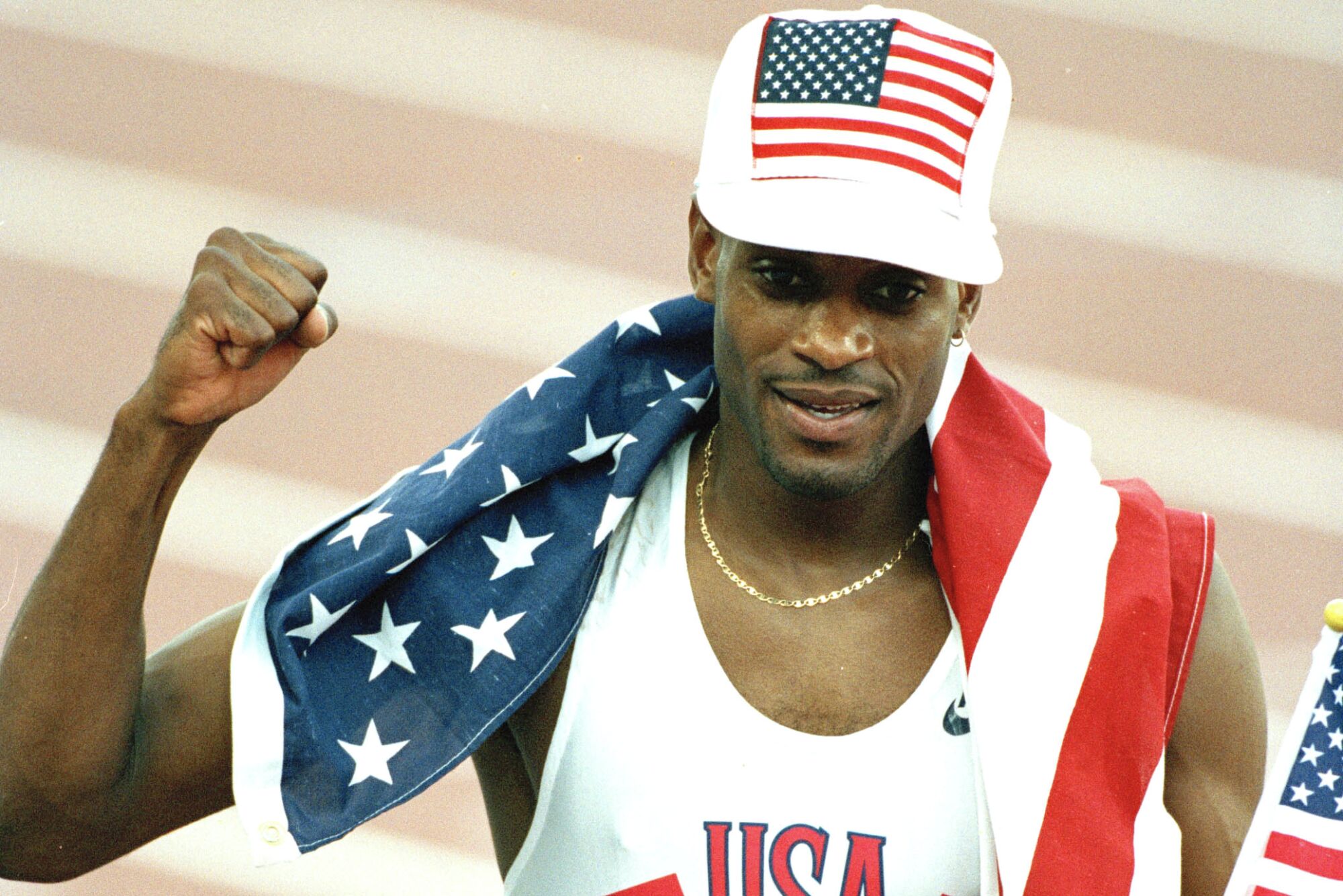 Kevin Young celebrates after winning gold in the men's 400-meter hurdles at the 1992 Barcelona Olympic Games.