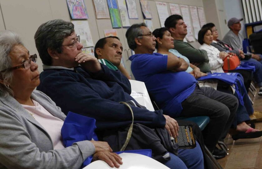 Potential enrollees at a North Hills screening event for Covered California and Medi-Cal in February. Hundreds of thousands of Medi-Cal applications have been delayed as the state and counties struggle with computer systems.