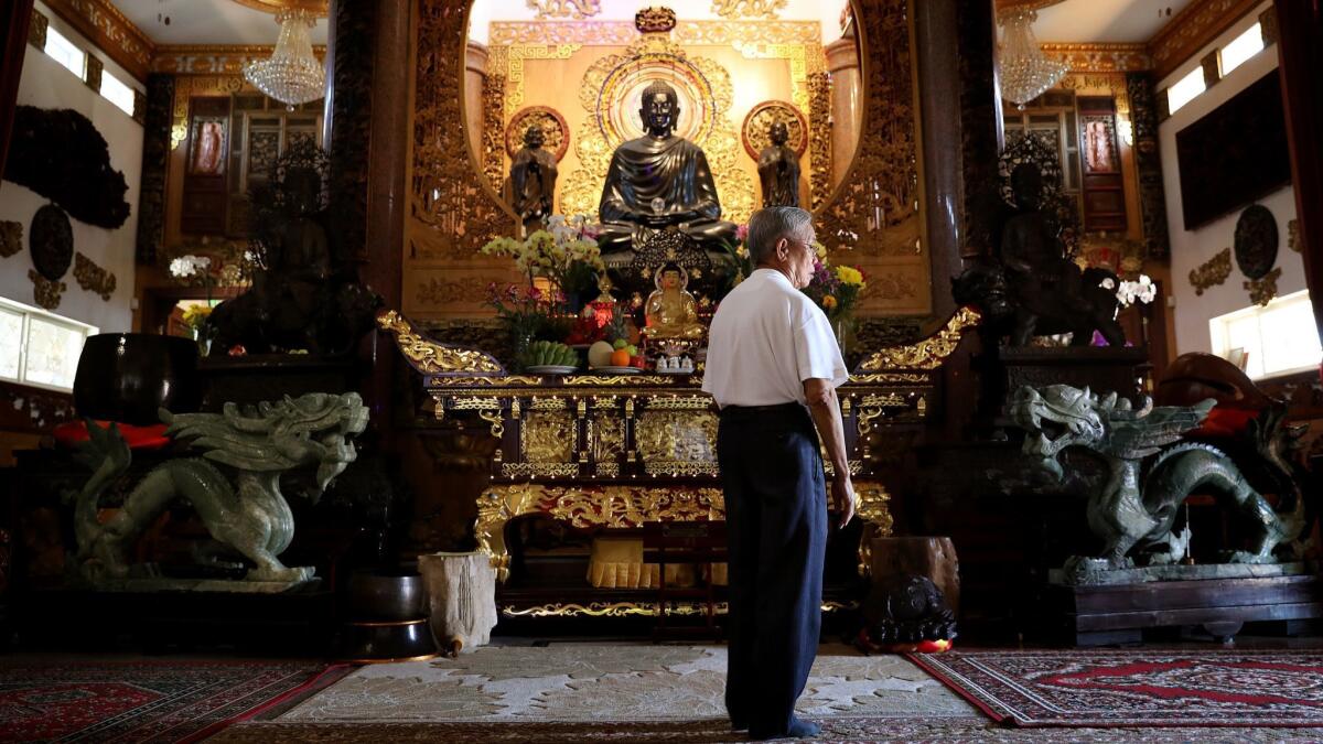 A man visits Bao Quang Temple in Santa Ana, one of several Buddhist temples in Orange County to be vandalized in recent weeks.