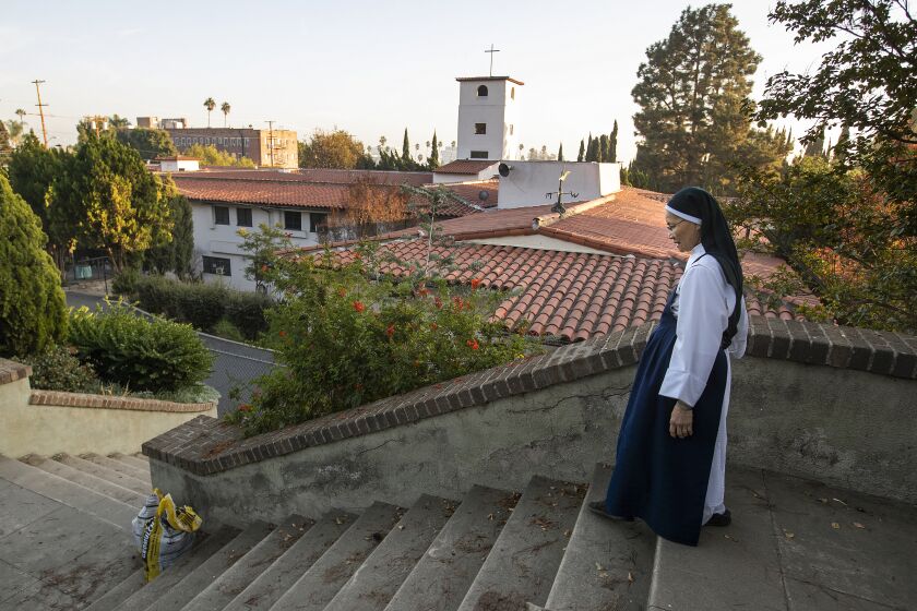 Hollywood, CA - December 01, 2021: Sister Mary John, a cloistered Dominican nun, is photographed on the grounds of the Monastery of the Angels in Hollywood, where she lives. Neighborhood organizers and friends of the Monastery of the Angels are gearing up for a battle to save the 90 year old home of the order of cloistered Dominican nuns after hearing that the building will go up for sale in 2022. (Mel Melcon / Los Angeles Times)