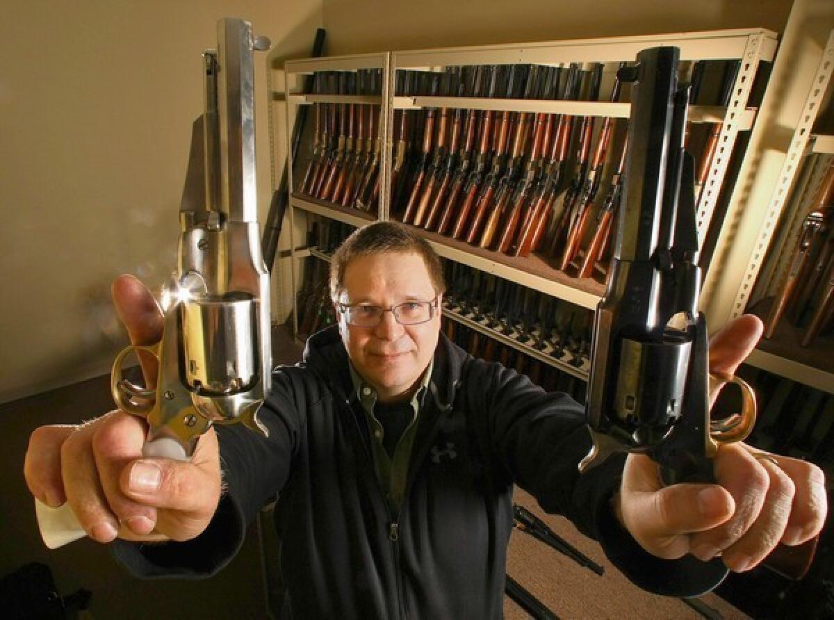Larry Zanoff, an armorer who worked on the movie "Django Unchained," holds up 1858 Remington revolvers that were used in the movie. Zanoff was photographed inside the western room at Independent Studio Services in Sunland.