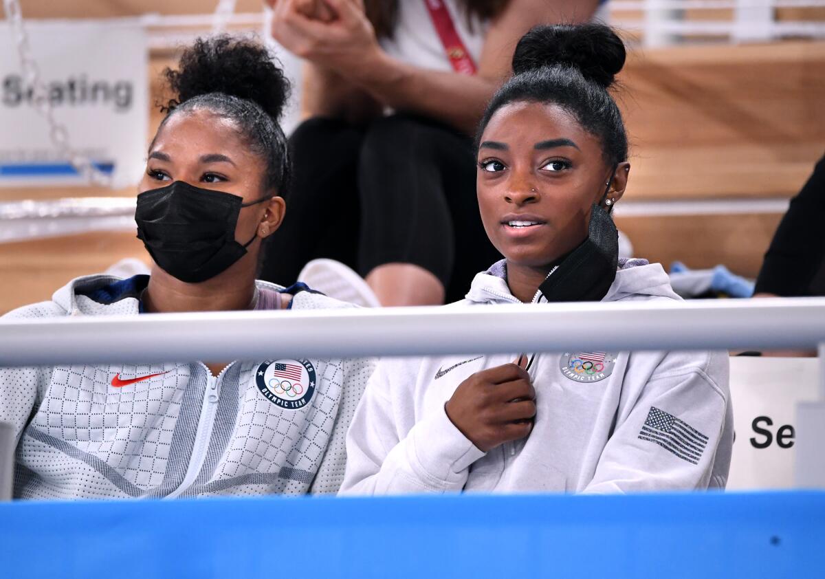 U.S. gymnasts Simone Biles, right. and Jordan Chiles watch the women's individual all-around final at the Tokyo Olympics.