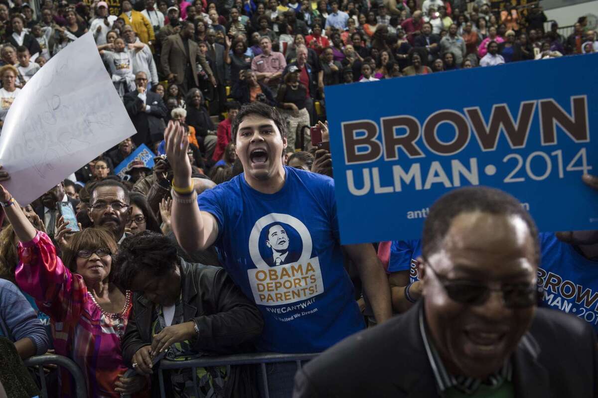 An immigration activist yells at President Obama during a campaign event in Maryland this month.
