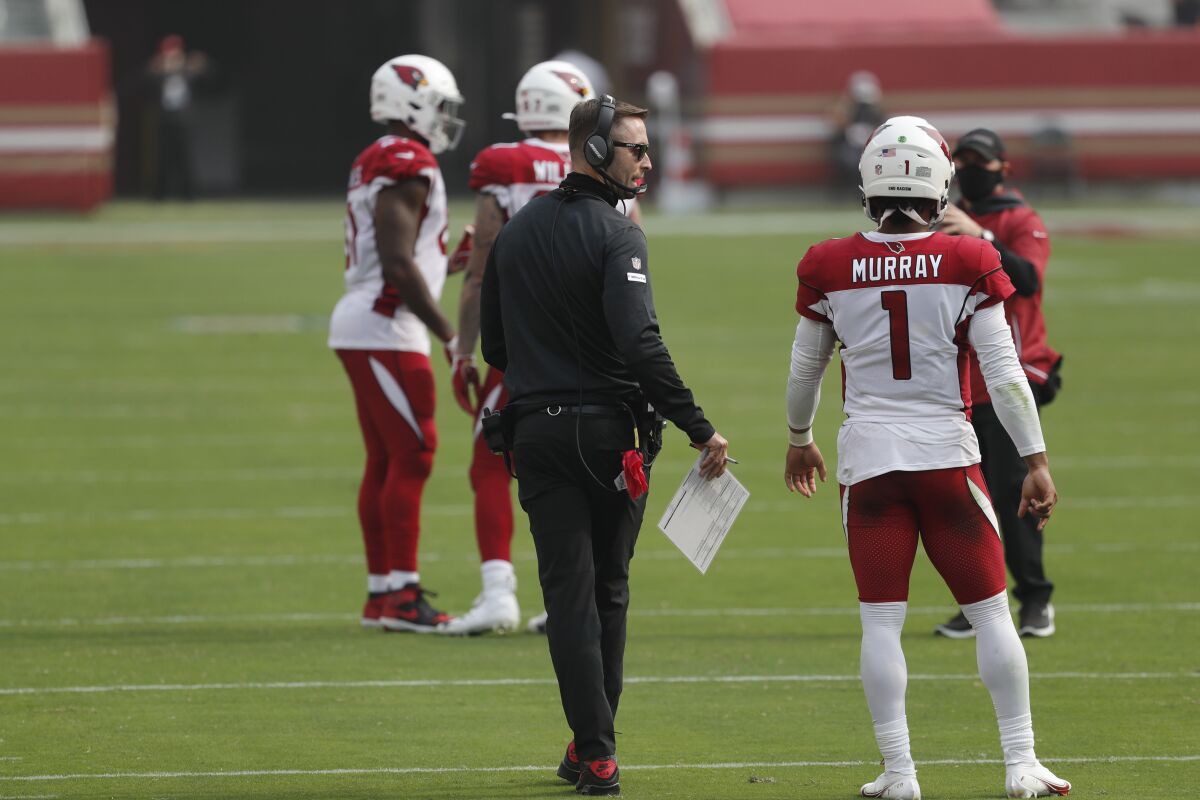 Cardinals head coach Kliff Kingsbury talks with quarterback Kyler Murray (1). 