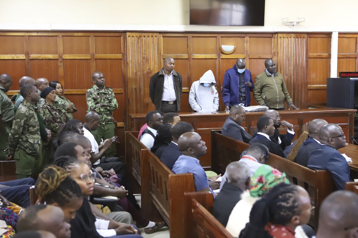 Kenya police officers in dock from left to right sentenced Peter Ngugi Kamau, 20 years, Sylvia Wanjiku Wanjohi, 24 years, Stephen Cheburet Morogo, 30 years and Fredrick Leliman, life sentence at Kenya's Milimani court Friday Feb.3, 2023. A former Kenyan policeman has been sentenced to death for the murder of a human rights lawyer, his client and a taxi driver. Frederick Leliman and three other police officers were charged with the murder of lawyer Willie Kimani and two others in 2016, in yet another case of police brutality and extrajudicial killings in Kenya. (AP photo) f