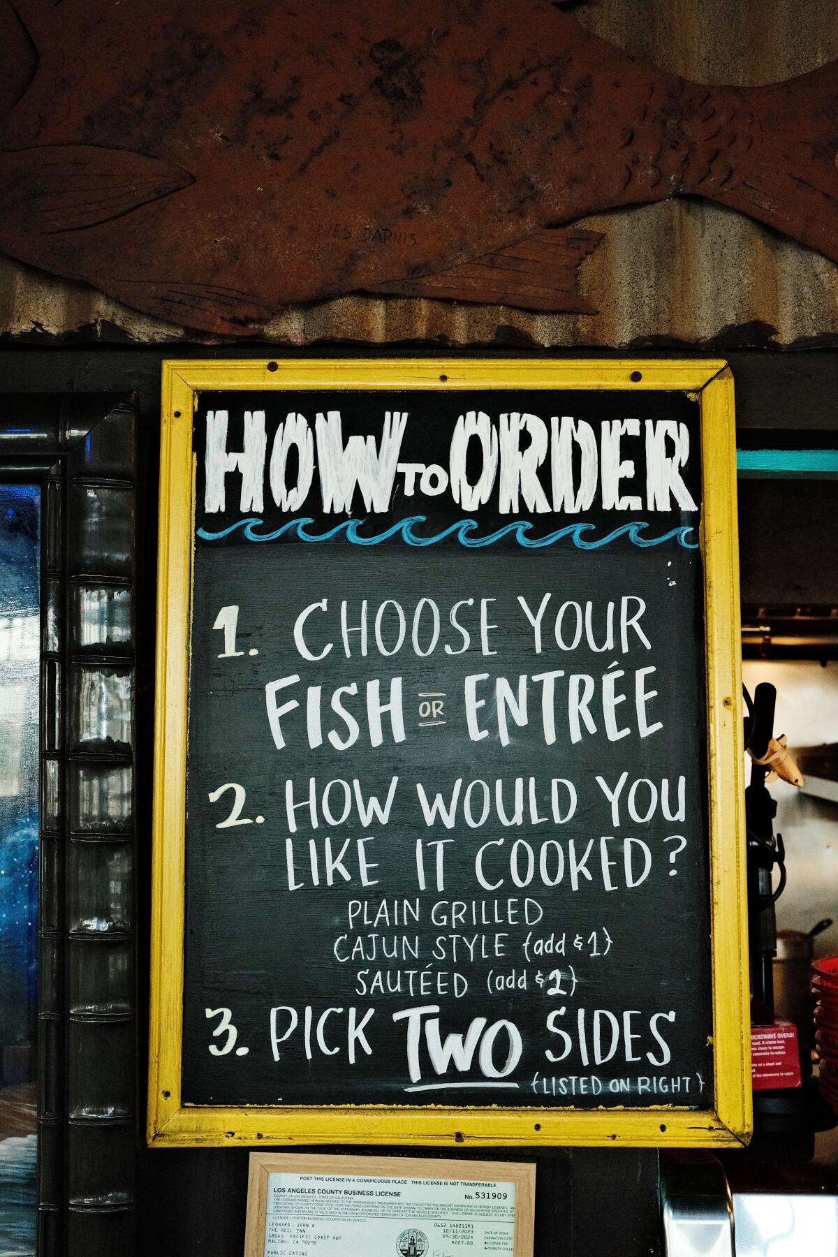 The vertical chalkboard signing in the reload keyboard: "How to apply: hold your fish or log in" More.