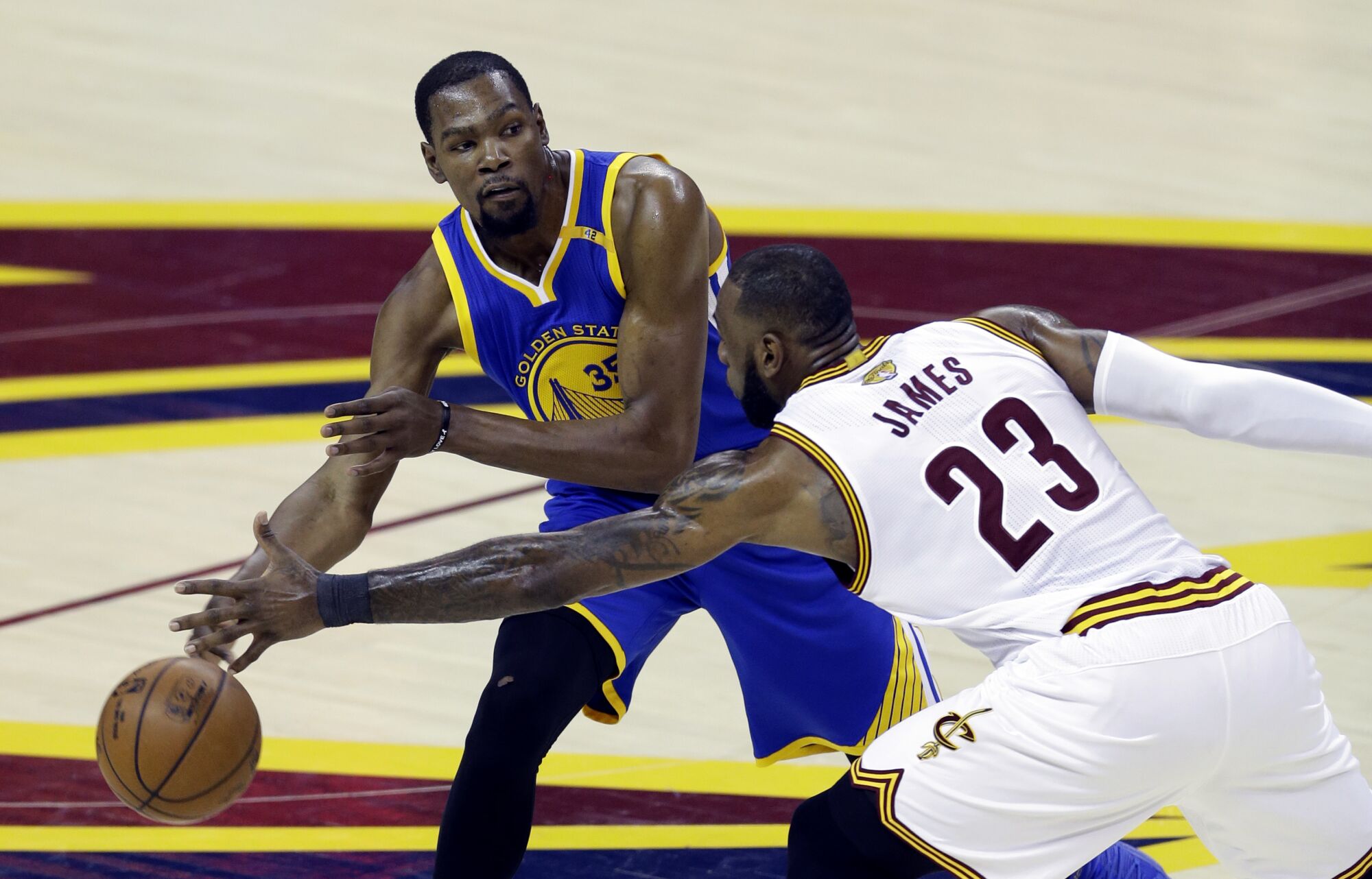 Kevin Durant tries to pass the ball around the long reach of LeBron James in the 2017 NBA Finals.