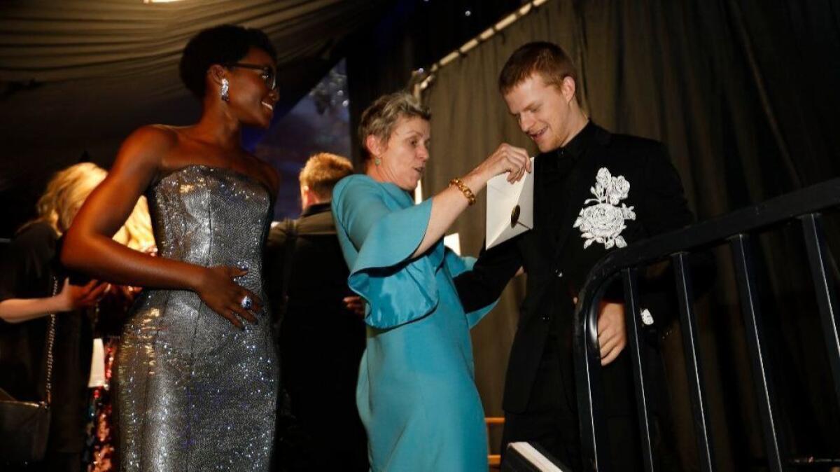 Presenter Lupita Nyong'o with Frances McDormand backstage with co-star Lucas Hedges after the ensemble cast win for "Three Billboards Outside Ebbing, Missouri."