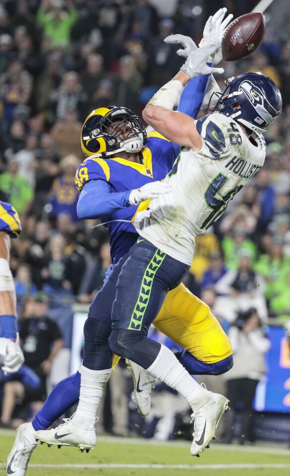 Rams linebacker Travin Howard knocks the ball away from Seattle Seahawks tight end Jacob Hollister.