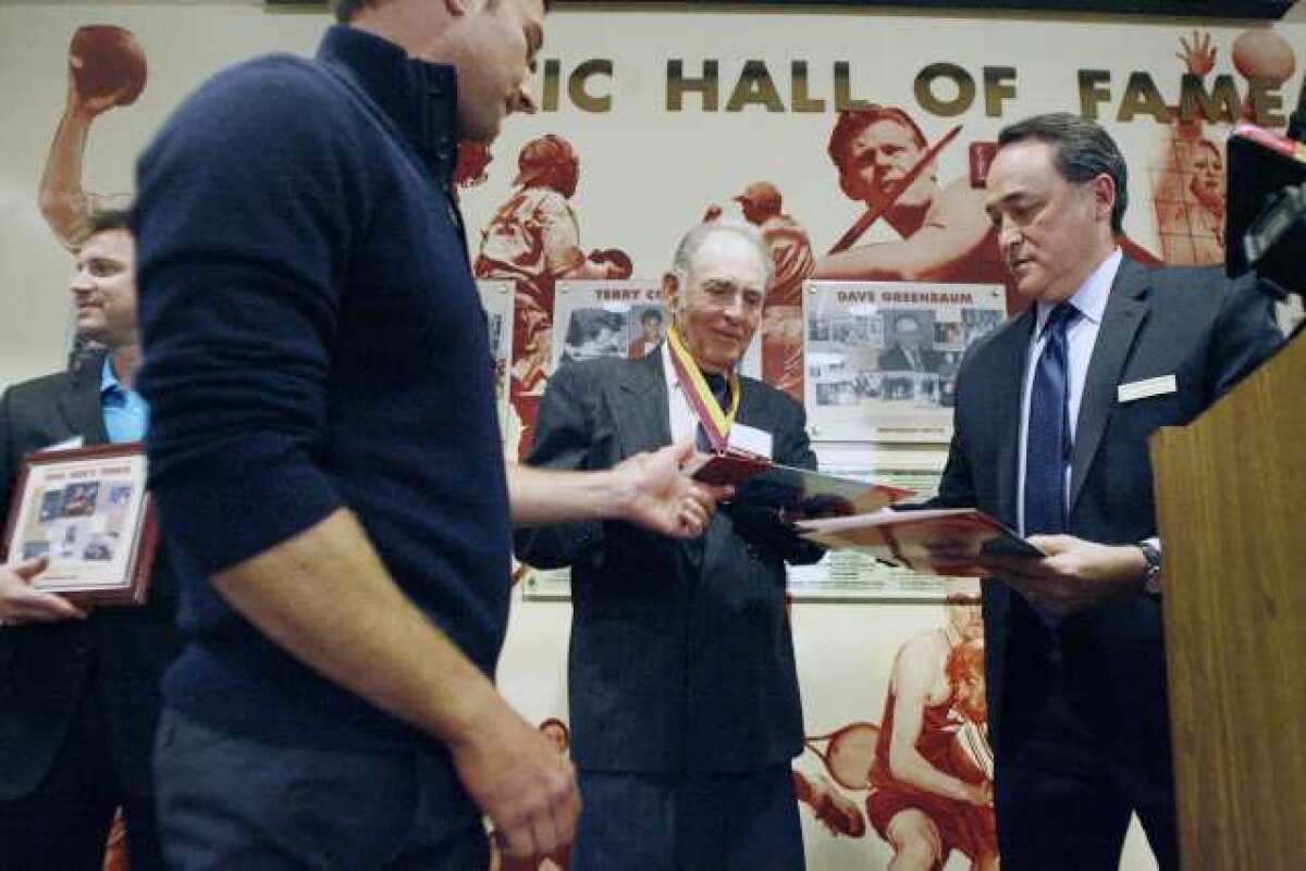 Kevin White, from left, Hakop Tadevosian, and GCC's tennis coach Bob Mackay receive their awards from Dr. Paul Schlossman during the Glendale Community College Athletic Hall of Fame, which took place at the Walter J. Smith Center in Glendale on Saturday, March 9, 2013.