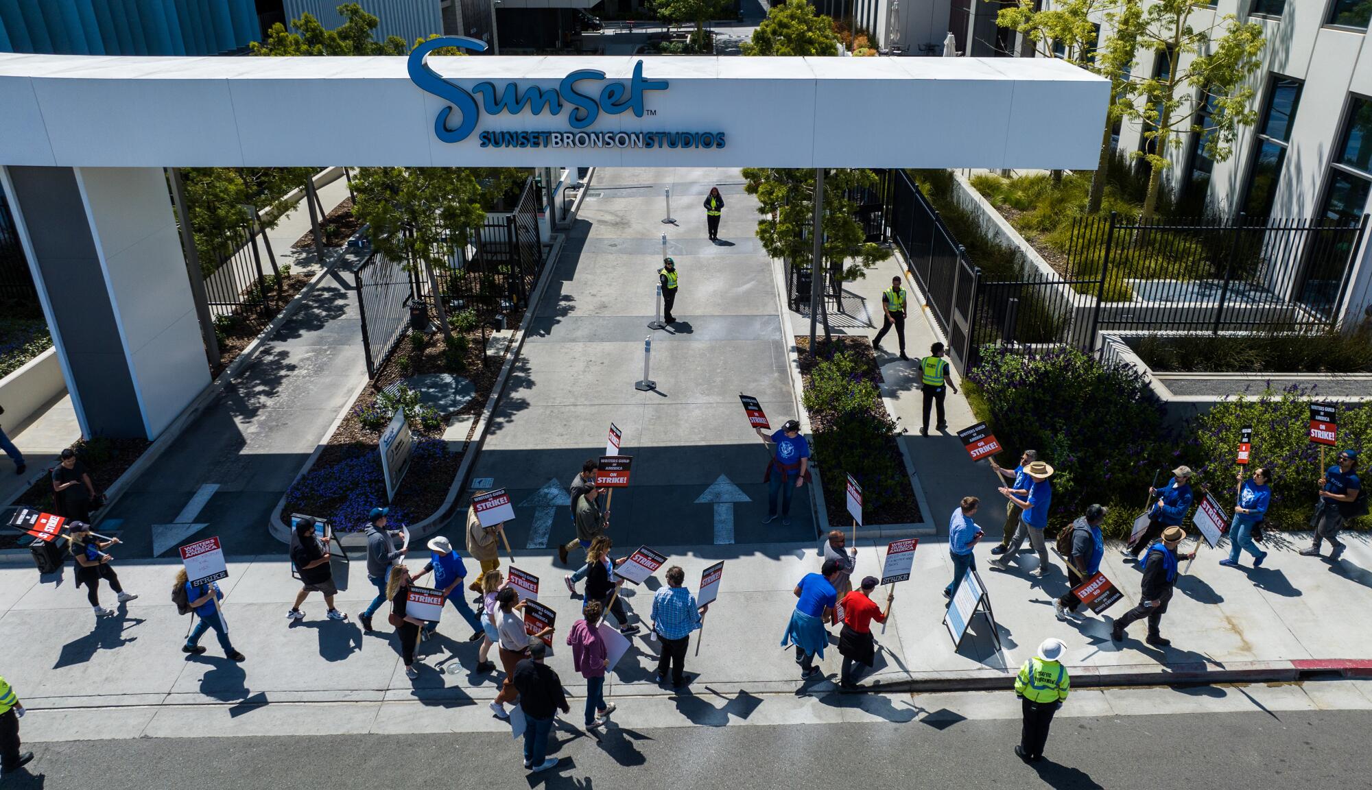 WGA members walk a picket line around the Bronson Sunset Studios lot 