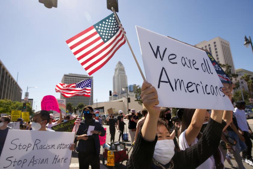 Protestors march at a rally against Asian hate crimes near the Los Angeles Federal Building in downtown Los Angeles on March 27, 202