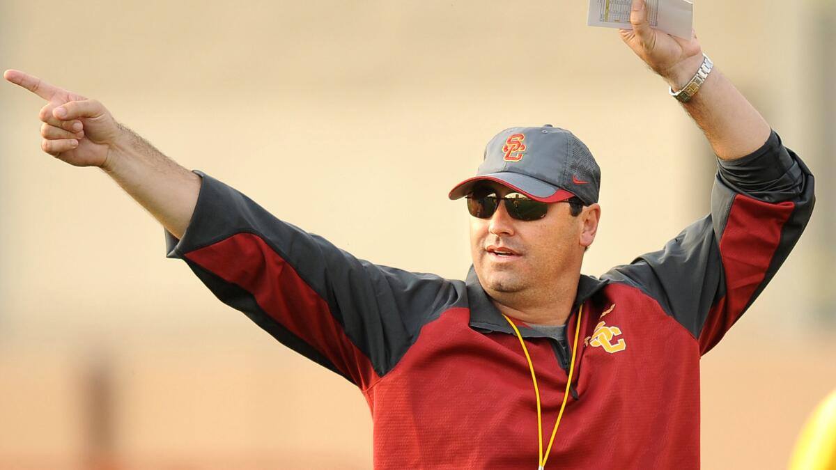 USC head coach Steve Sarkisian instructs his players during practice in March 2014 at the Trojan campus.
