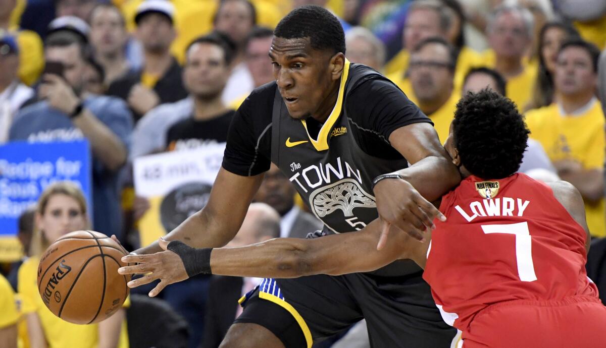 Warriors forward Kevon Looney tries to drive past Raptors guard Kyle Lowry during Game 6 of the NBA Finals on June 13, 2019.