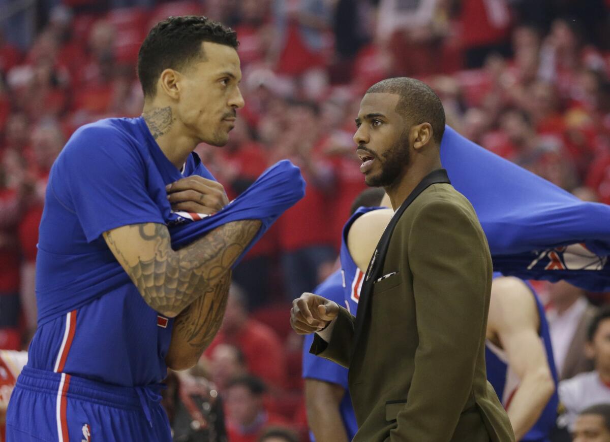 Injured Clippers point guard Chris Paul, right, talks with forward Matt Barnes before Game 1 of the Clippers' second-round matchup with the Houston Rockets.
