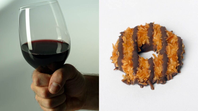 The Vivino app has put together a guide to pairing wine with Girl Scout cookies. On the left, a glass of red wine. On the right, a Samoa Girl Scout cookie.