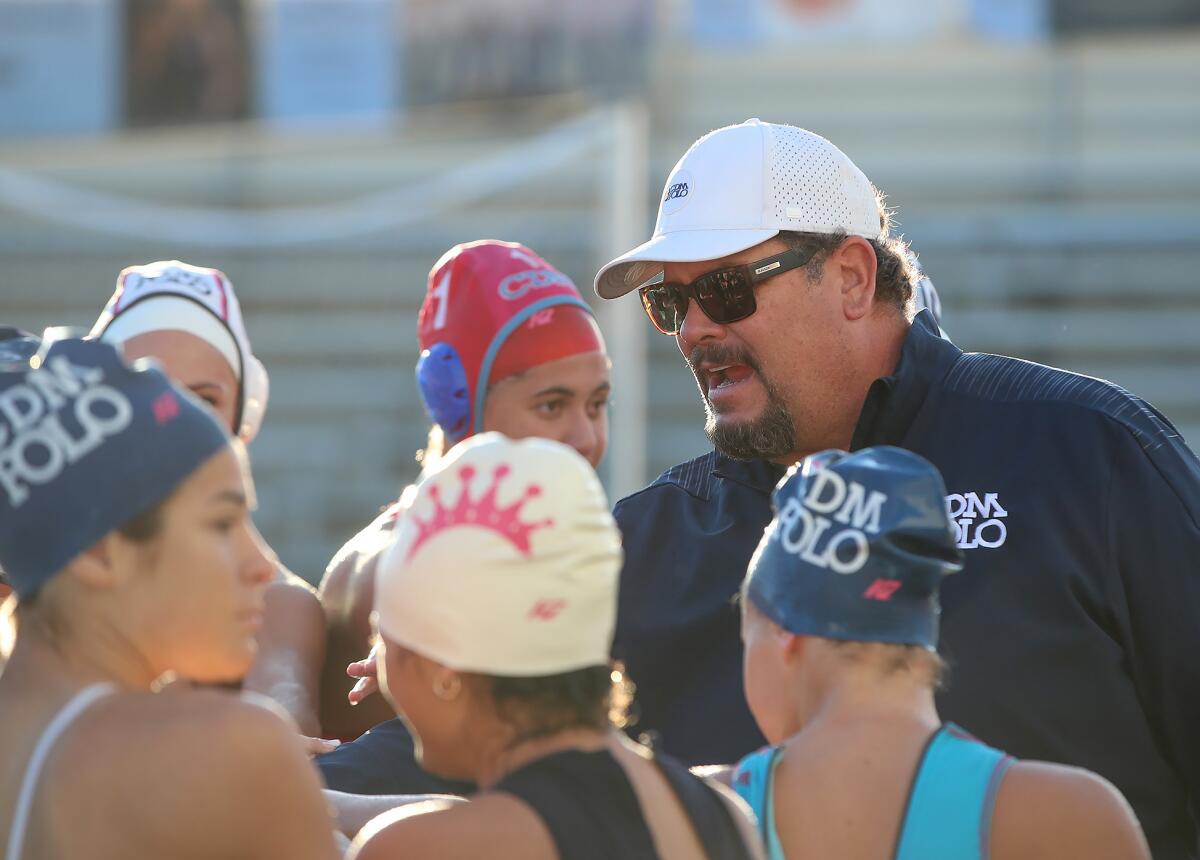 First-year head coach Marc Hunt leads the girls' water polo team at Corona del Mar during a practice on Thursday.