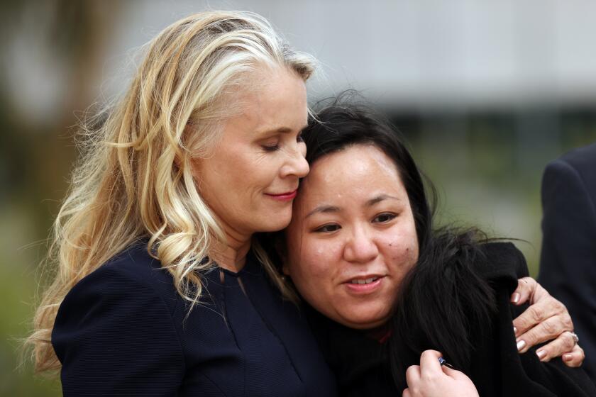 LOS ANGELES, CA - MARCH 25: Audry Nafziger, left, hugs Lucy Chi, right, after speaking during a press conference about their sexual abuse by USC gynecologist George Tyndall and the settlement against University of Southern California at the Westin Bonaventure Hotel in downtown on Thursday, March 25, 2021 in Los Angeles, CA. (Dania Maxwell / Los Angeles Times)