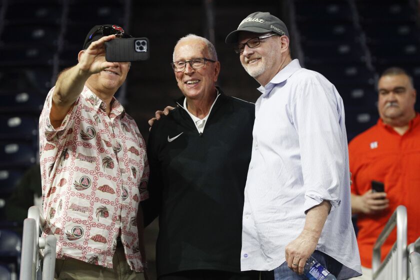 Houston, Texas - March 31: Former San Diego State head coach Steve Fisher, center, takes a selfie with fans during a practice leading up to the Final Four at the NRG Stadium on Friday, March 31, 2023 in Houston, Texas. (Meg McLaughlin / The San Diego Union-Tribune)