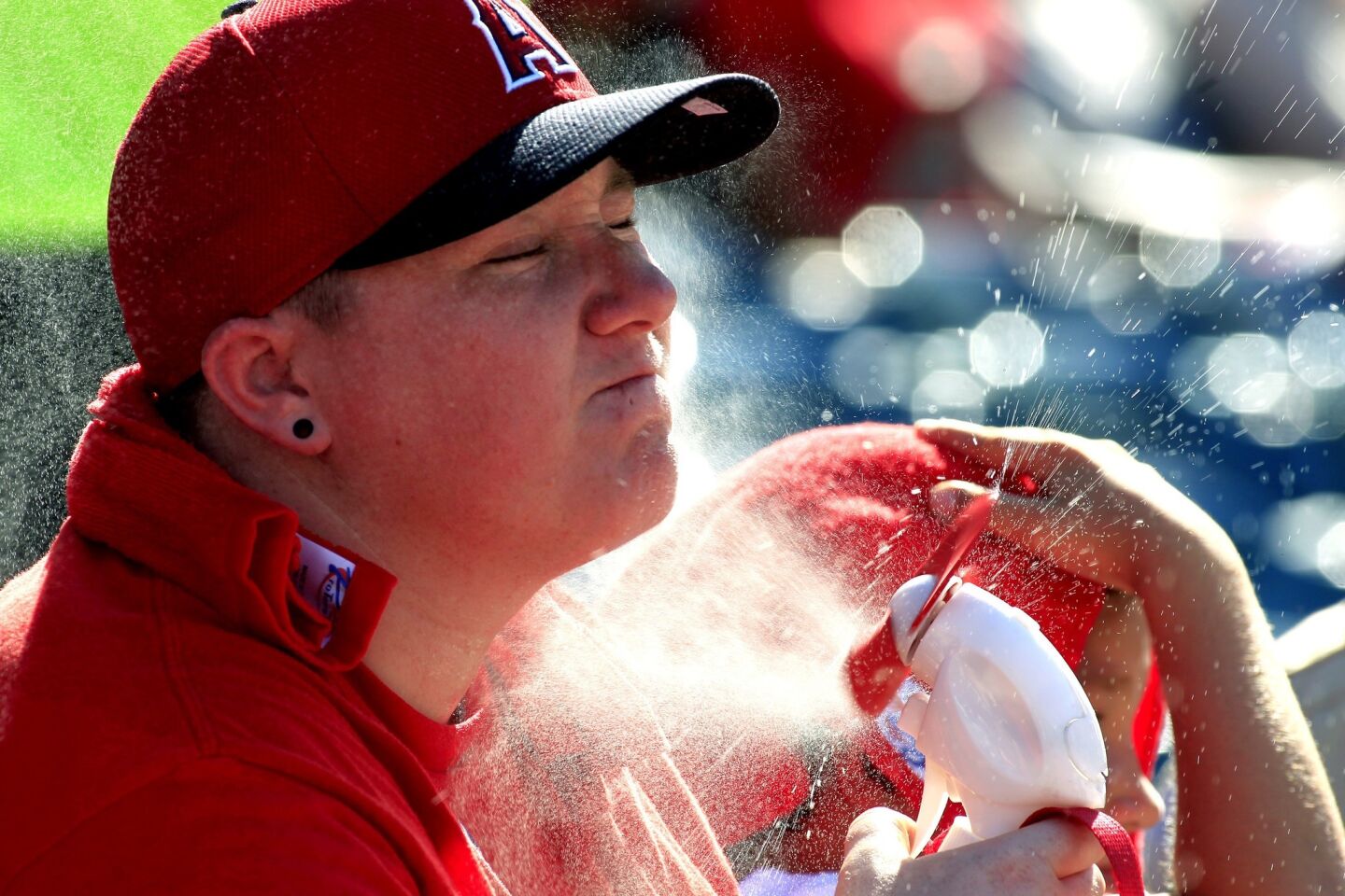 Stacia Watniarski of Riverside cools off while the Angels play the Houston Astros in Anaheim on Sunday.