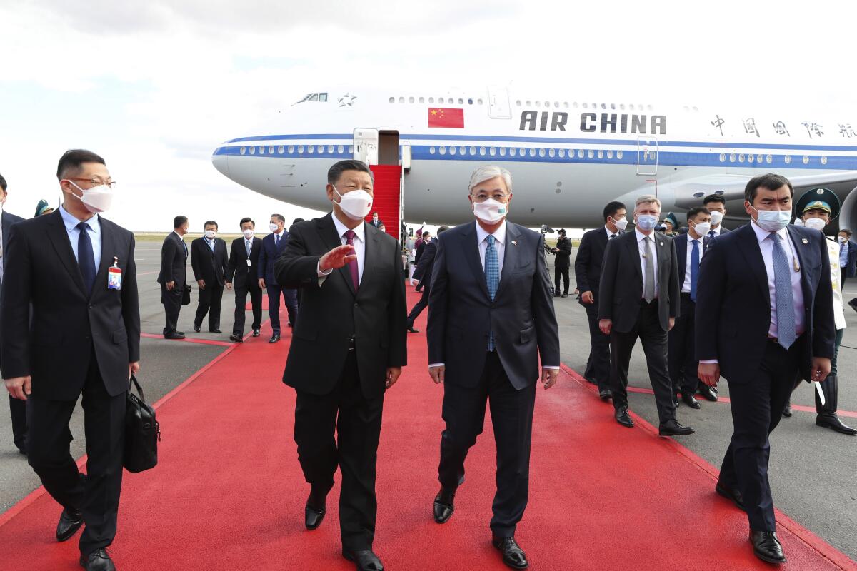 Xi Jinping walks away from an Air China plane with Kassym-Jomart Tokayev.