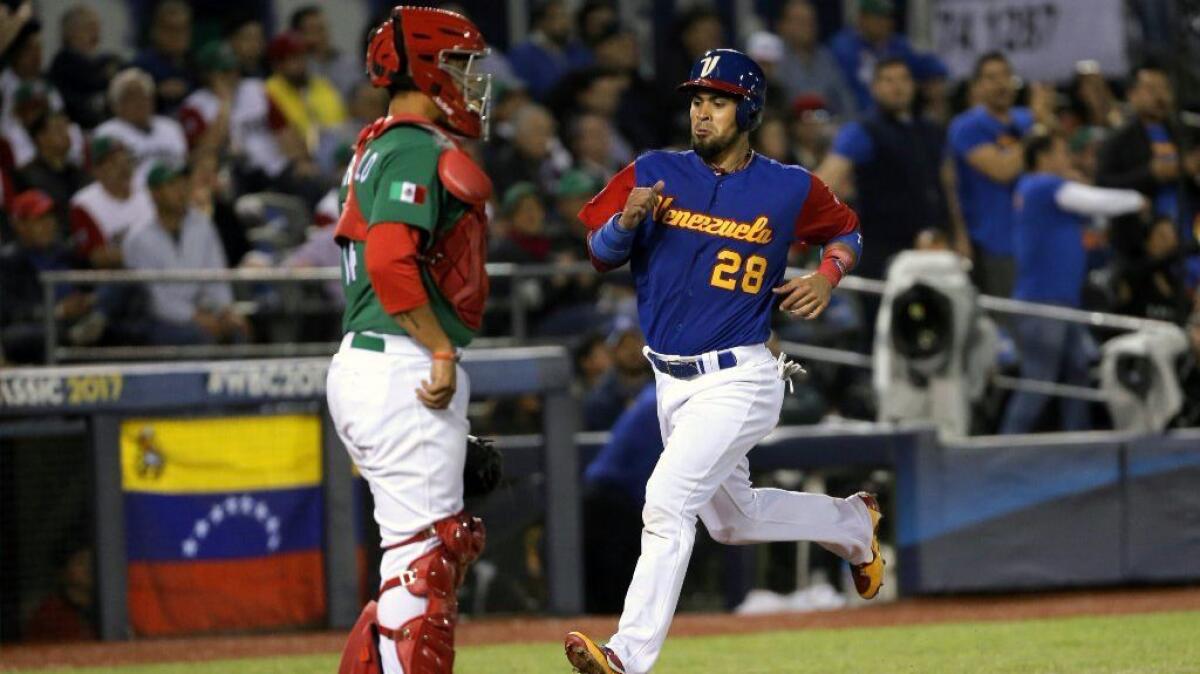 Venezuela's Robinson Chirinos (28) scores during the World Baseball Classic game against Mexico at Charros de Jalisco Stadium in Guadalajara on March 12.