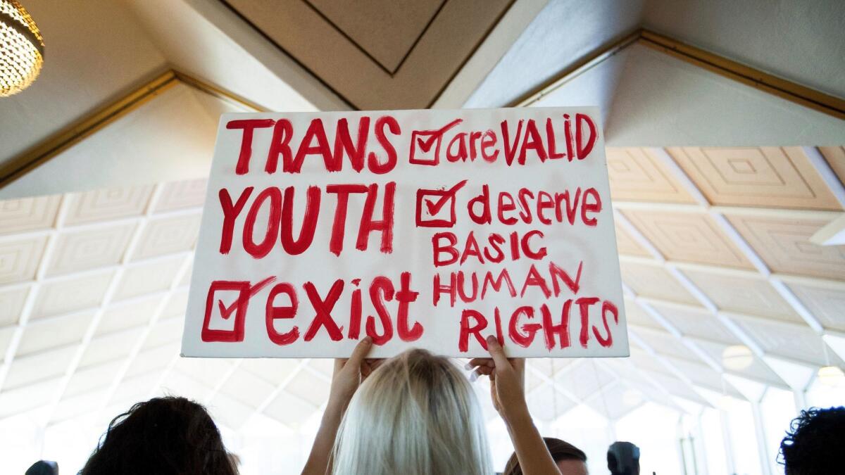 Hunter Schafer of Raleigh holds a sign in favor of repealing North Carolina HB2 during a special session of the General Assembly on Wednesday.