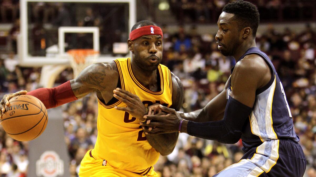 Cavaliers forward LeBron James drives to the basket against Grizzlies forward Jeff Green during a preseason game on Oct. 12.