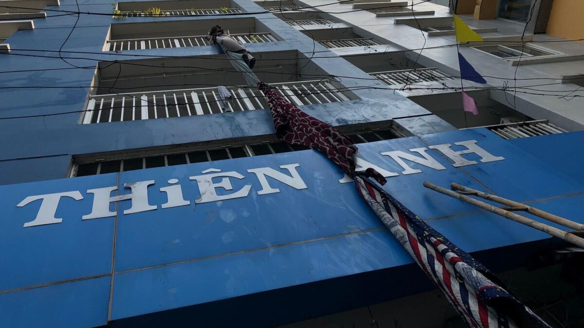 An improvised escape rope hangs from a balcony after a fire in Ho Chi Minh City.