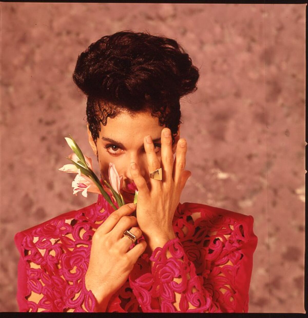 Prince holds a flower