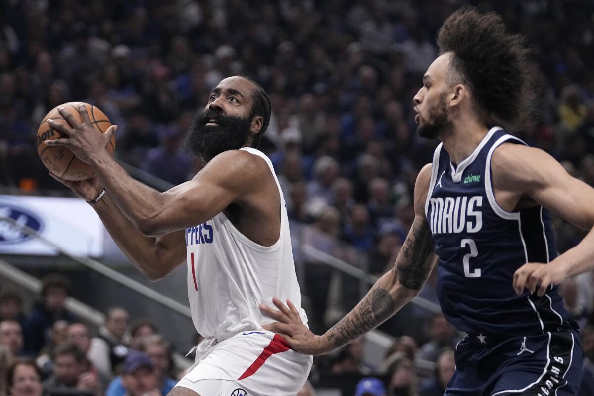James Harden drives to the basket as Dallas' Dereck Lively II defends in the first half.