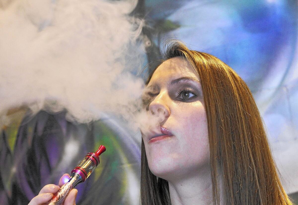 Former co-owner Crystal Galbraith shows how to smoke an electronic cigarette at the recently-opened Crystal Vapor, 2259 Foothill Blvd. in La Cañada Flintridge, on Monday, August 19, 2013.