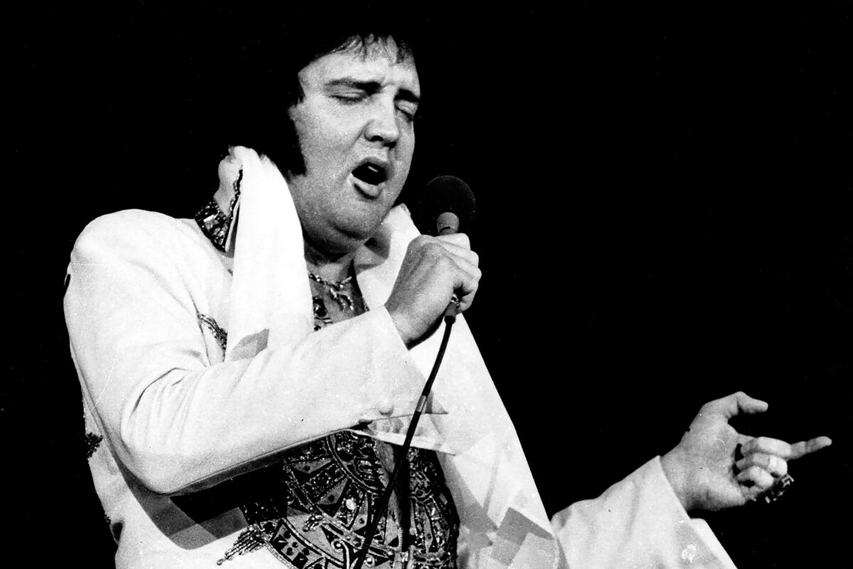 Elvis Presley singing into a microphone.