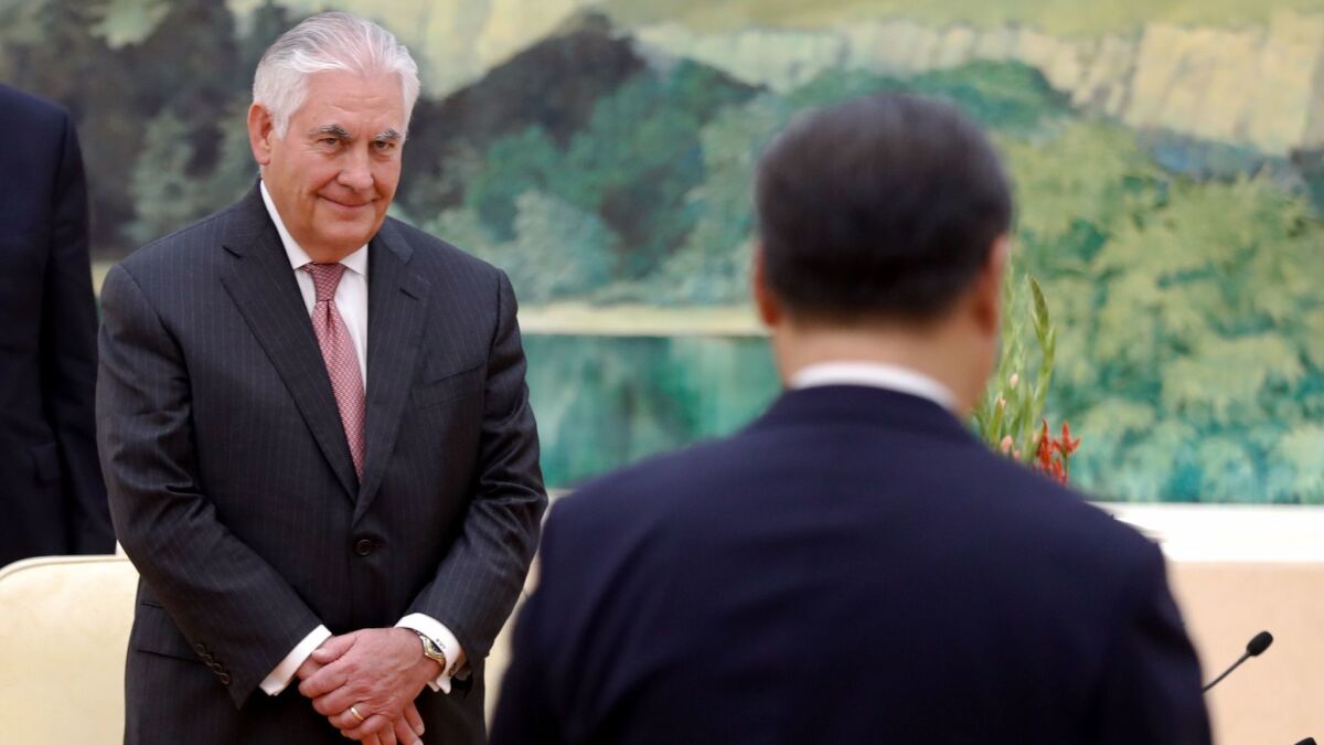 Secretary of State Rex Tillerson, left, looks at China's President Xi Jinping during a meeting in Beijing on Sept. 30.