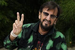 Ringo Starr, wearing a green and black denim jacket, flashes a peace sign at the Hotel Sunset Marquis in West Hollywood