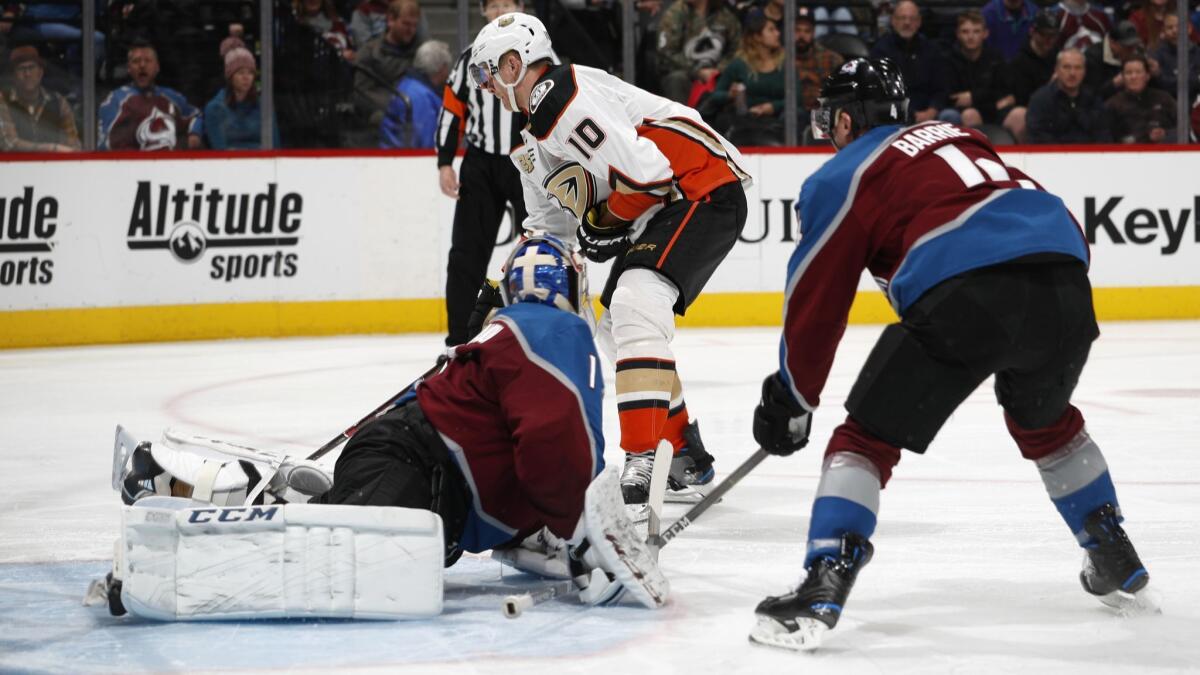 Ducks right wing Corey Perry, back, shoots the puck for a goal past Colorado Avalanche goaltender Semyon Varlamov, front left, and defenseman Tyson Barrie during the second period on Friday in Denver.