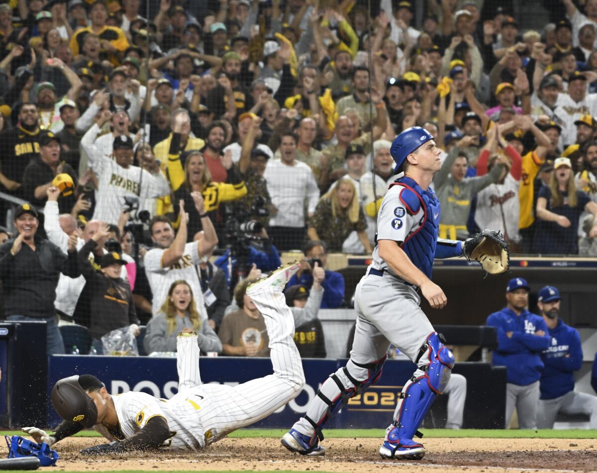 Juan Soto dives to score for the Padres.