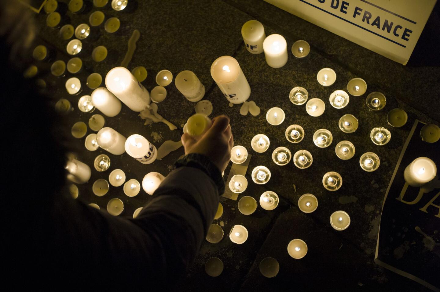 People light candles in front of the Danish embassy in Paris on Feb. 15 to pay tribute after the terrorist attacks in Copenhagen, Denmark.