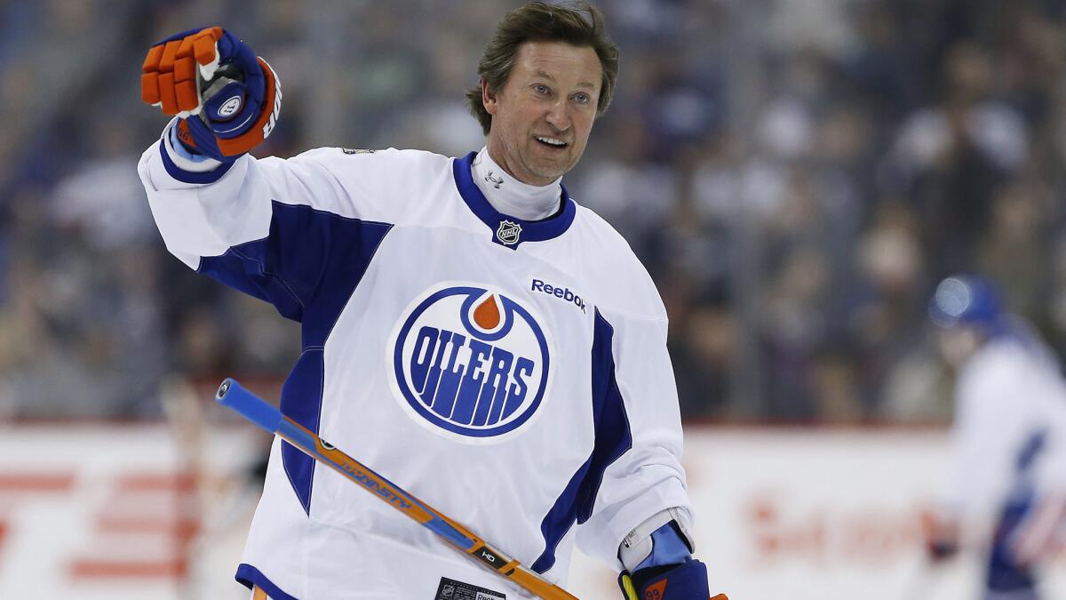 Hall of Famer Wayne Gretzky waves to the crowd during a practice for the NHL's Heritage Classic Alumni game in Winnipeg on Oct. 21. He recently returned to the NHL as an Edmonton Oilers executive.