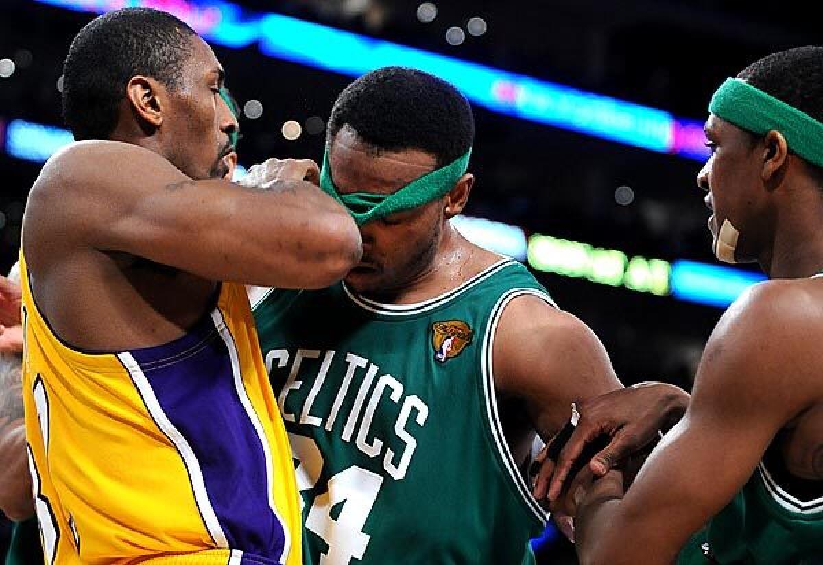 Lakers forward Ron Artest and Celtics forward Paul Pierce go face to face after getting tangled while battling for rebounding position in the first half of Game 7 of the 2010 NBA Finals.