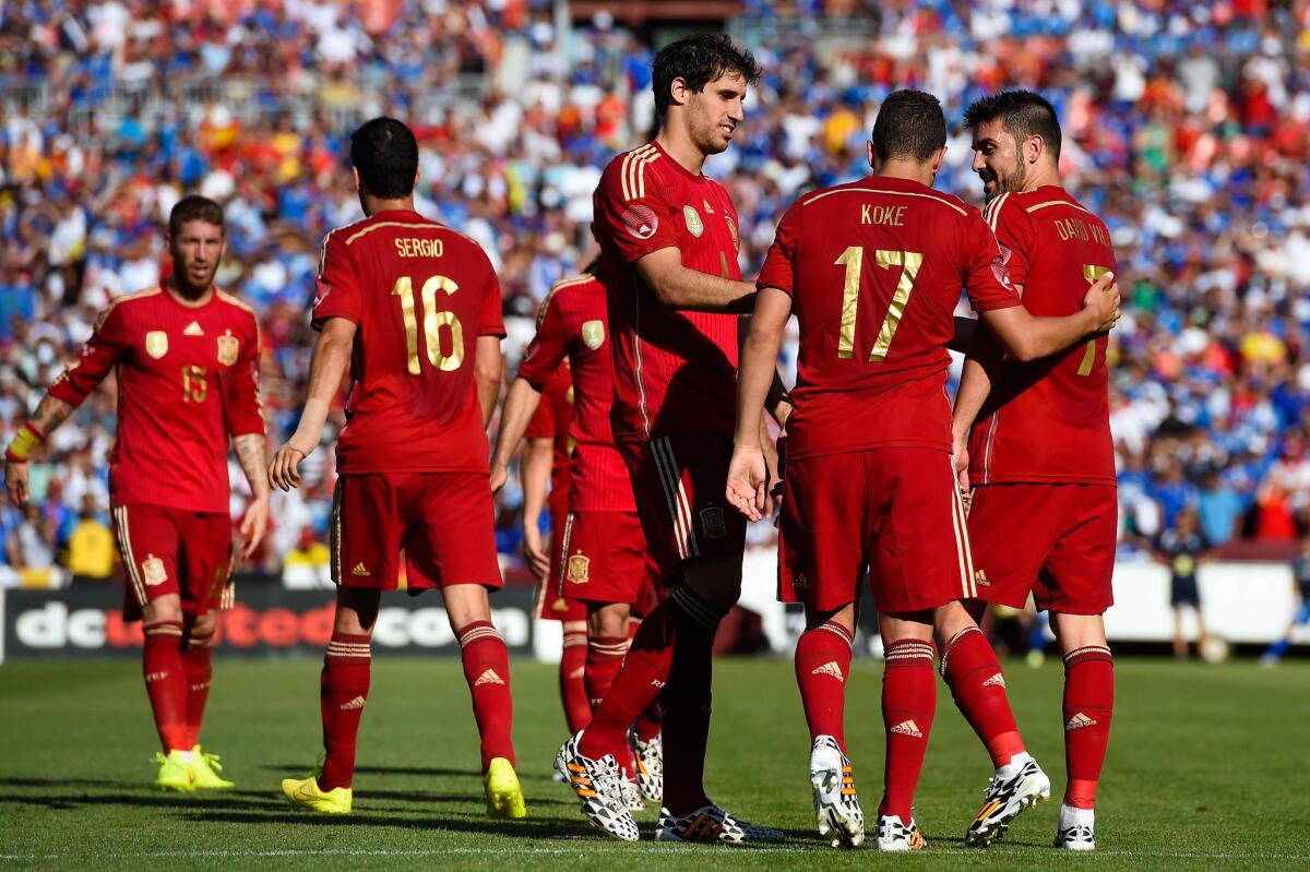 David Villa of Spain, right, celebrates with his teammates after scoring his team's second goal during an international friendly match against El Salvador.