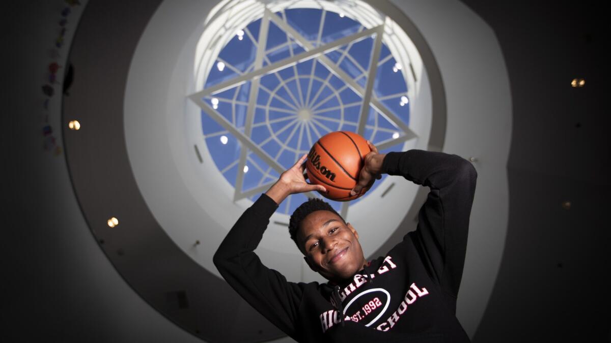 Jacob Benezra poses for a photo in the foyer at Shalhevet High School.