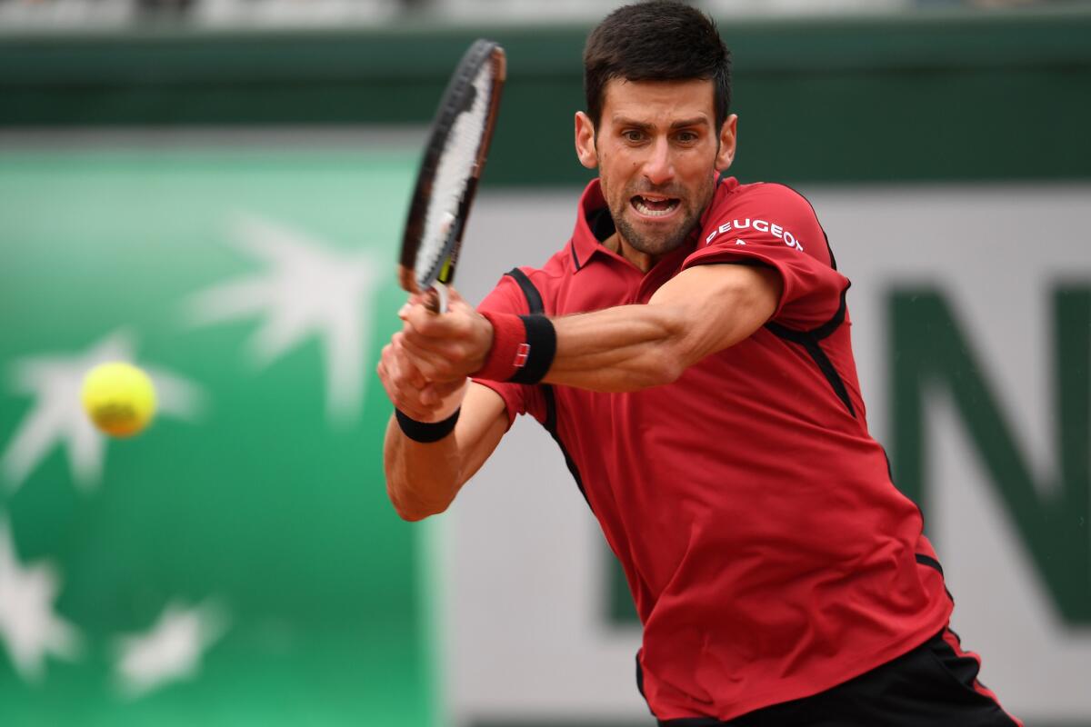 Novak Djokovic hits a backhand against Dominic Thiem at the French Open on Friday.