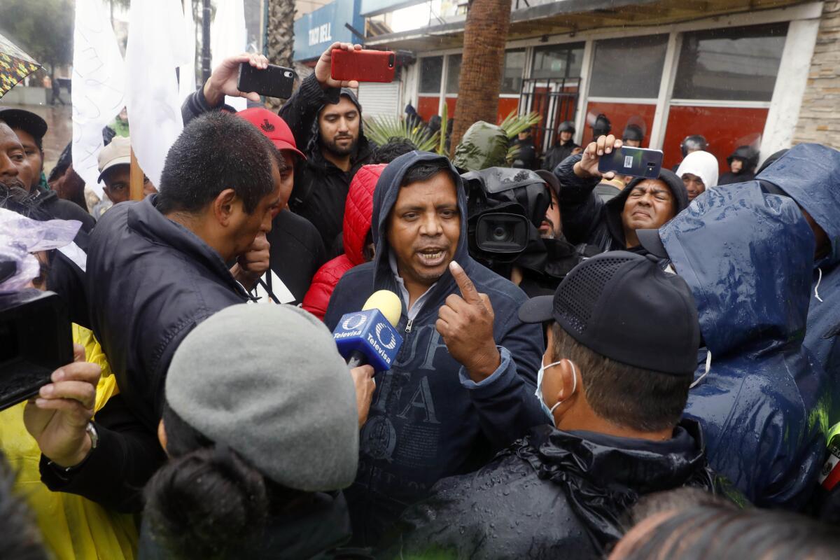 Irineo Mujica, center, a leader with Pueblo Sin Fronteras, and caravan migrants participating in a hunger strike are blocked by Mexican federal police from marching to the Chaparral port of entry in Tijuana on Nov. 29, 2018.