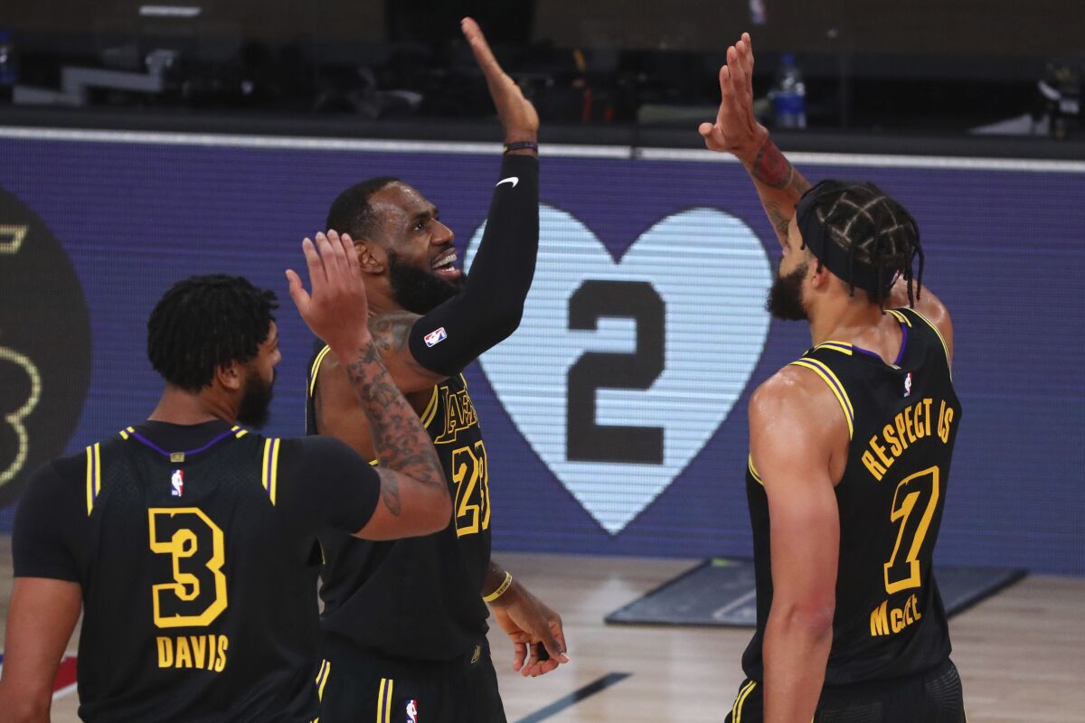 Lakers forward LeBron James celebrates after scoring a three-point basket.