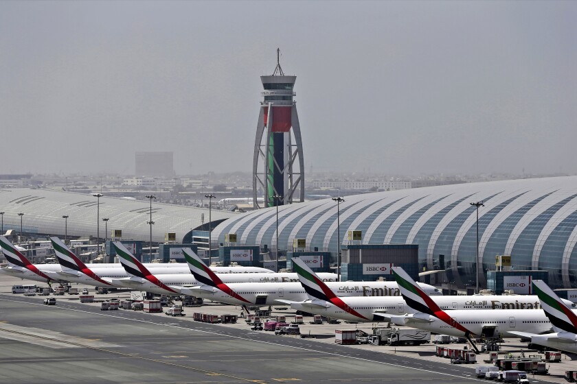 FILE - In this April 20, 2017, file photo, Emirates planes are parked at the Dubai International Airport in Dubai, United Arab Emirates. The Middle East's largest airline, Emirates, announced on Tuesday a net loss of $5.5 billion over the past year as revenue fell by more than 66% due to global travel restrictions sparked by the coronavirus pandemic. (AP Photo/Kamran Jebreili, File)