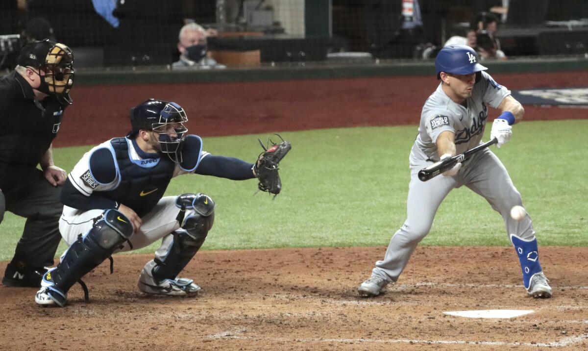 Dodgers catcher Austin Barnes lays down a sacrifice bunt to bring in a run during the fourth inning.