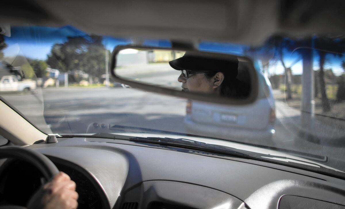 Claudia Bedolla, here running an errand in Pomona, does not have a driver's license. She is among tens of thousands in the U.S. illegally who have already made a DMV appointment to apply for one.