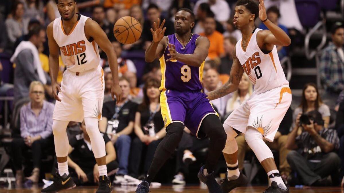 Lakers forward Luol Deng passes the ball during a game against the Phoenix Suns on Feb. 15.