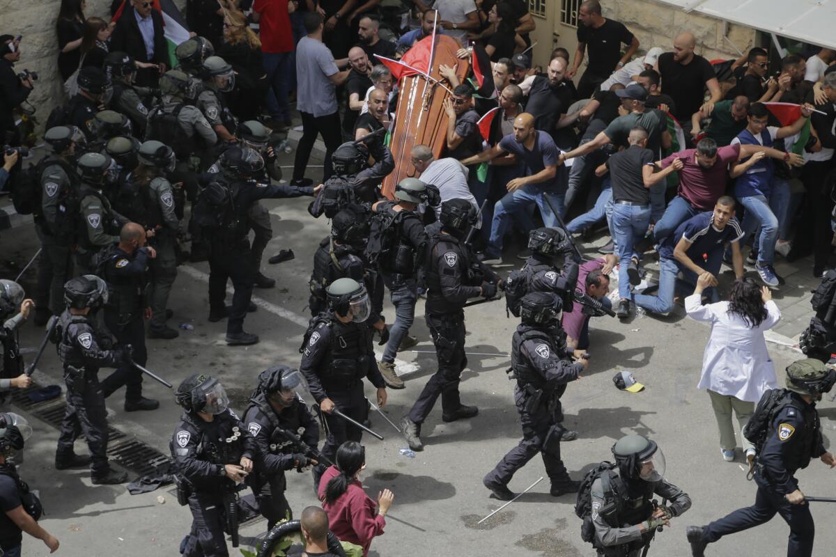 Police clash with mourners at a funeral in East Jerusalem.